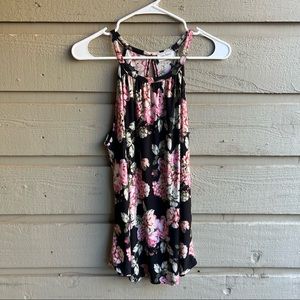 Black tank with pink and green floral pattern. Brand “free kisses” size large